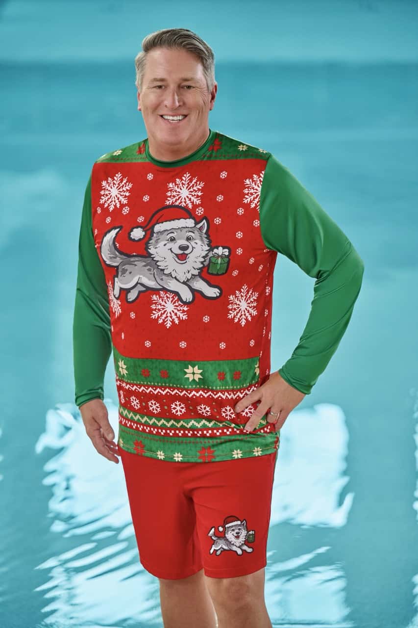 a man wearing a holiday themed swimwear in red and green